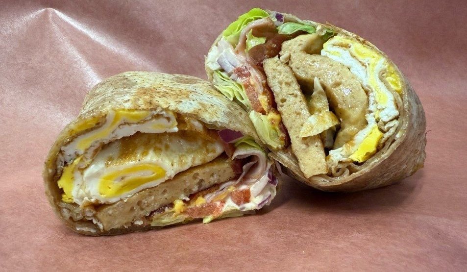 A breakfast wrap with egg and cheddar, cut in half